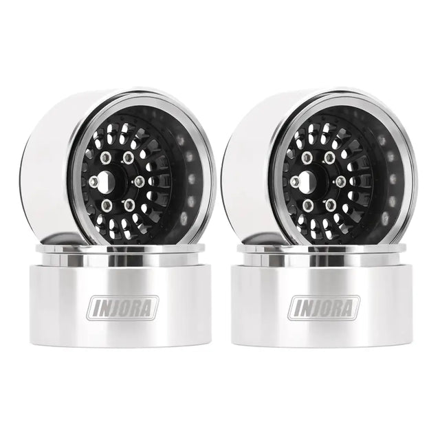 Pair of silver and black rc truck wheels with a sleek, polished metallic finish.