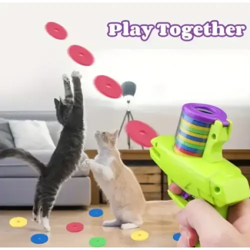 Bright green plastic toy gun with a rainbow-colored spiral magazine.