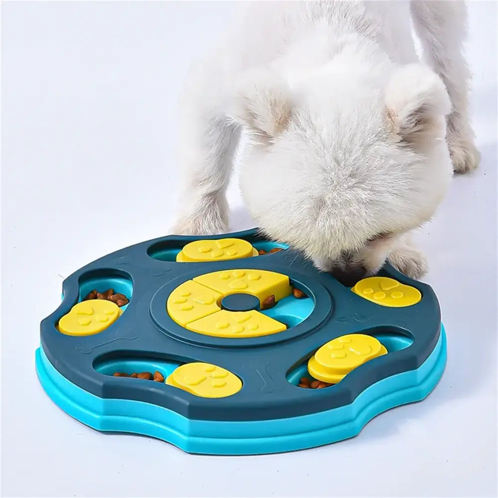 Blue and yellow plastic dog treat puzzle feeder with paw print designs.