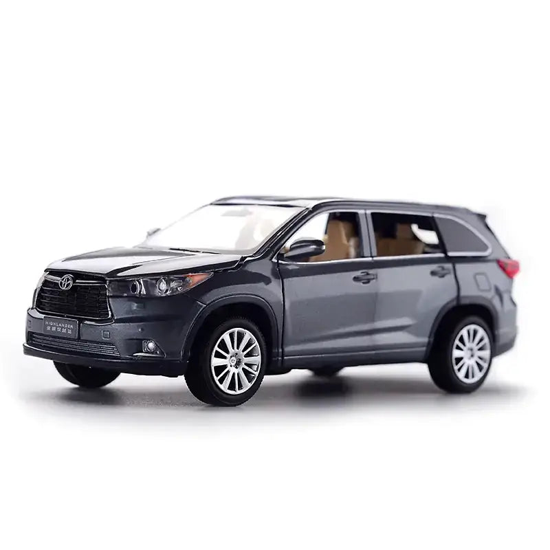 Dark gray metallic toyota highlander suv model toy with detailed chrome wheels and interior.