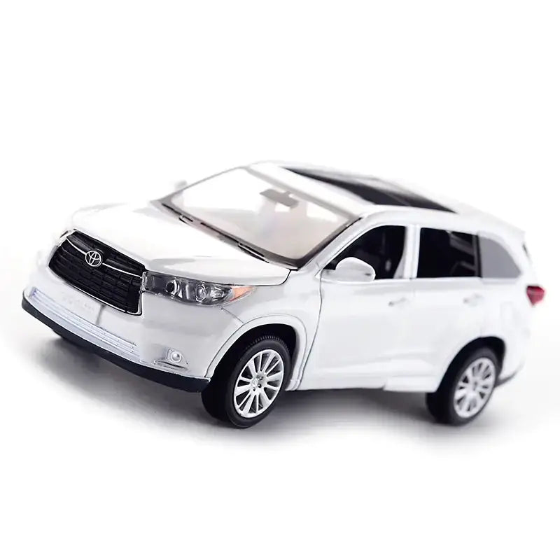 White die-cast toyota highlander suv model toy with black grille and roof, silver alloy wheels.