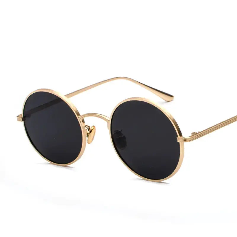 Gold-toned round sunglasses with dark lenses and a minimalist, retro design.