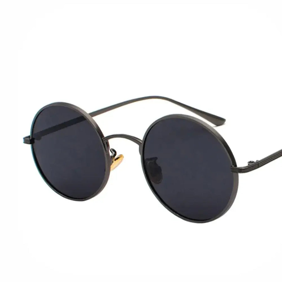 Black round-framed sunglasses with dark gray lenses and a gold-colored nose bridge.