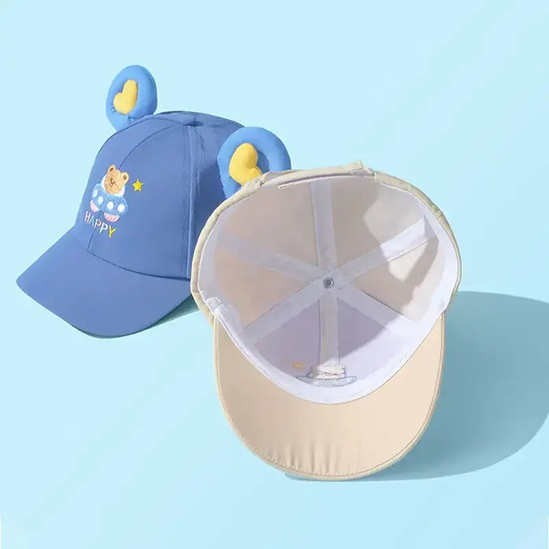 Blue toddler baseball cap with embroidered bear face and yellow ear accents.
