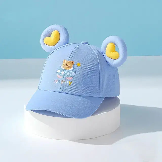 Light blue children’s baseball cap featuring embroidered bear face and yellow heart-shaped ears.