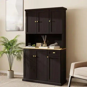 Black wooden cabinet with a light wood countertop and gold-toned hardware.
