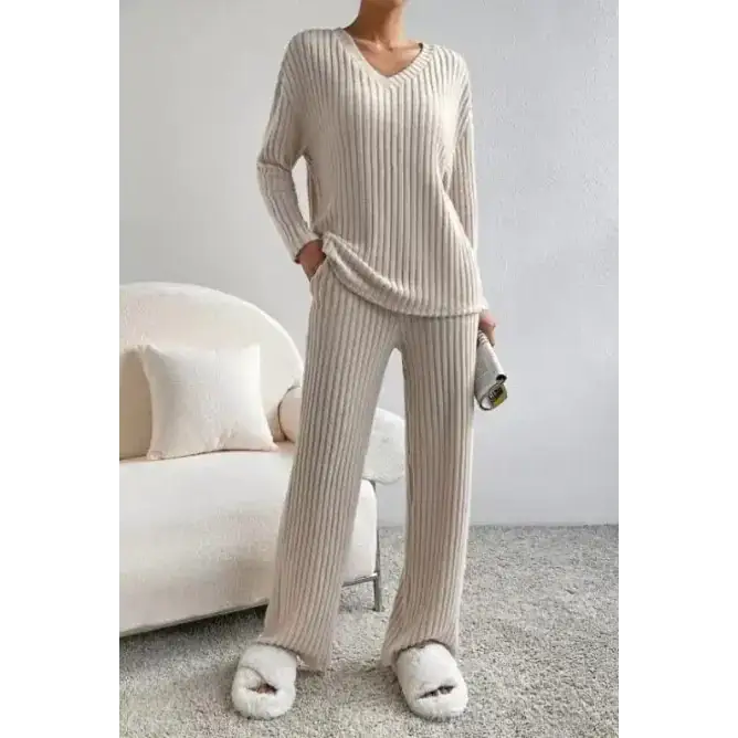 Cream-colored ribbed knit pajama set with long sleeves and wide-leg pants.