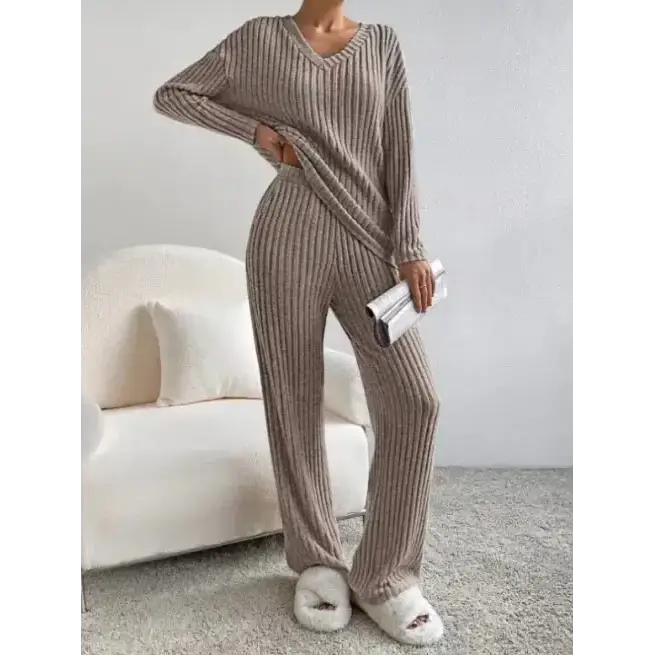 Beige ribbed knit two-piece loungewear set with a v-neck top and tapered pants.