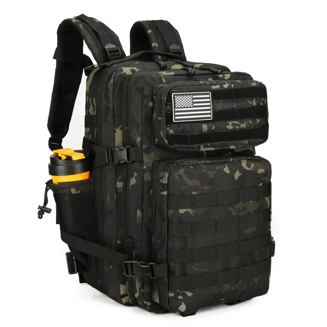 Black and olive green camouflage tactical backpack with a white american flag patch on the front pocket.