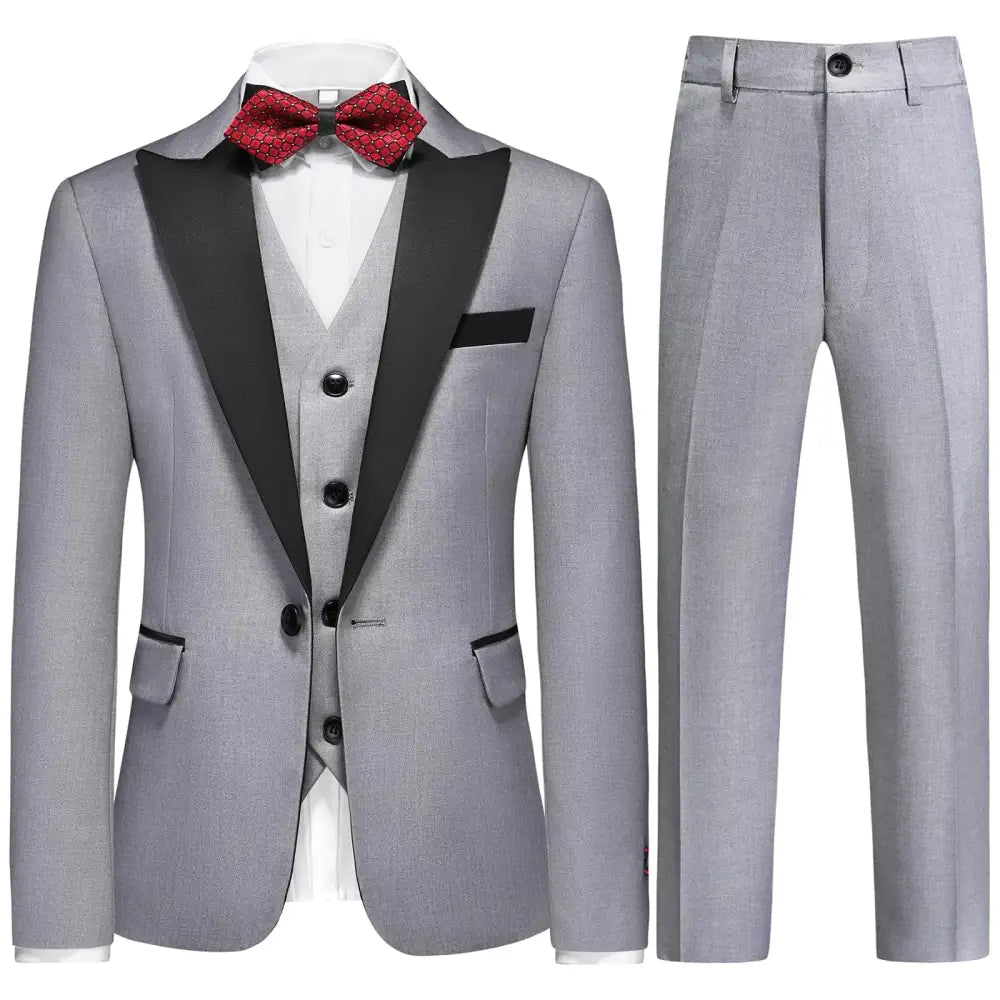Gray tuxedo suit with black satin lapels and matching vest, accented by a red patterned bow tie.