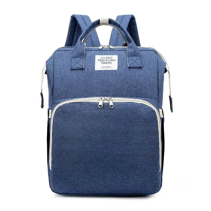 Blue denim-textured backpack with white zipper pulls and trim, featuring a front pocket and top handles.