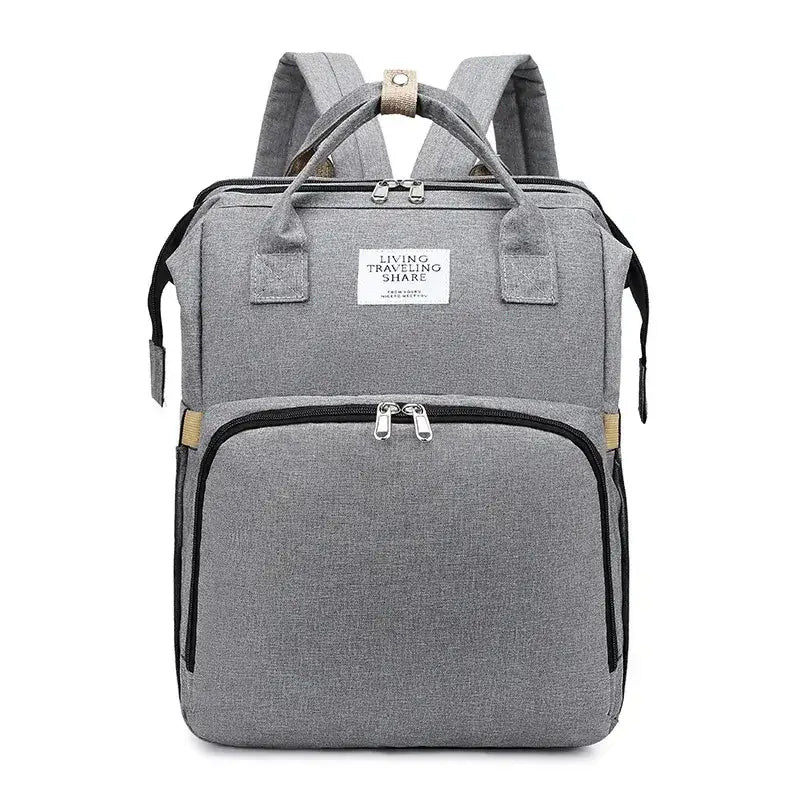 Gray textured fabric backpack with black zipper accents and beige trim details.