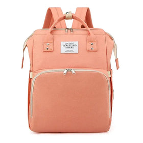 A peach-colored canvas backpack with beige zippers and straps, featuring a front pocket and top handles.