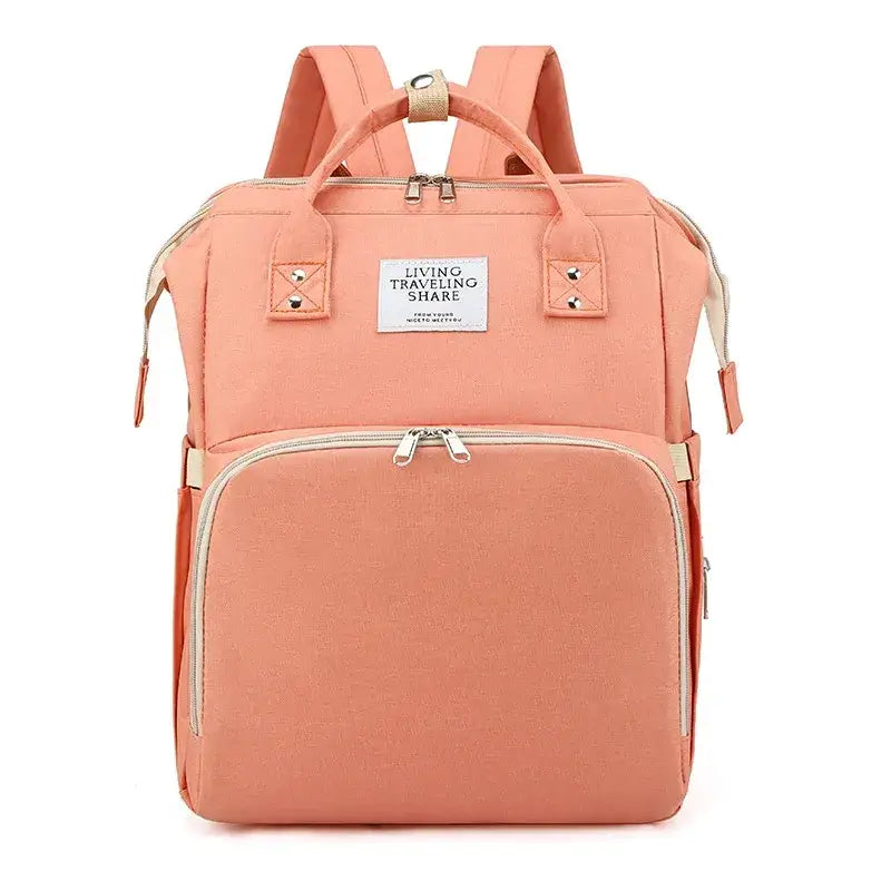 A peach-colored canvas backpack with beige zippers and straps, featuring a front pocket and top handles.