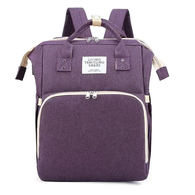Purple textured fabric baby backpack with beige trim and silver zippers.