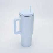 White insulated travel mug with a handle and a straw.