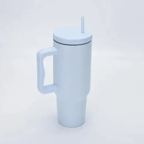 White insulated travel mug with a handle and a straw.