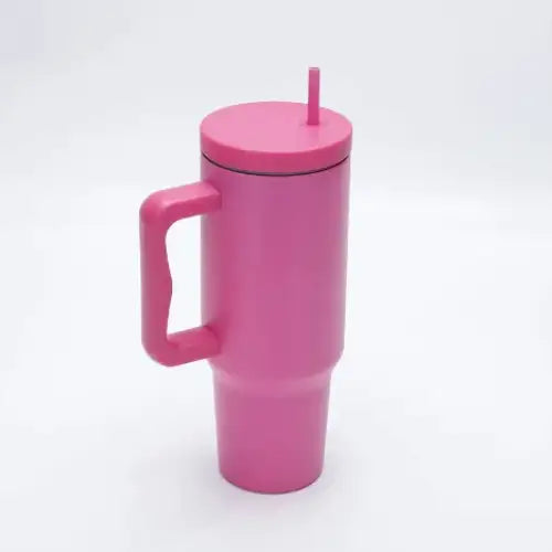 Pink insulated travel mug with a matching lid and handle, featuring a sleek metallic finish.