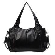 Black faux leather shoulder bag with two zipped side pockets and a detachable strap.