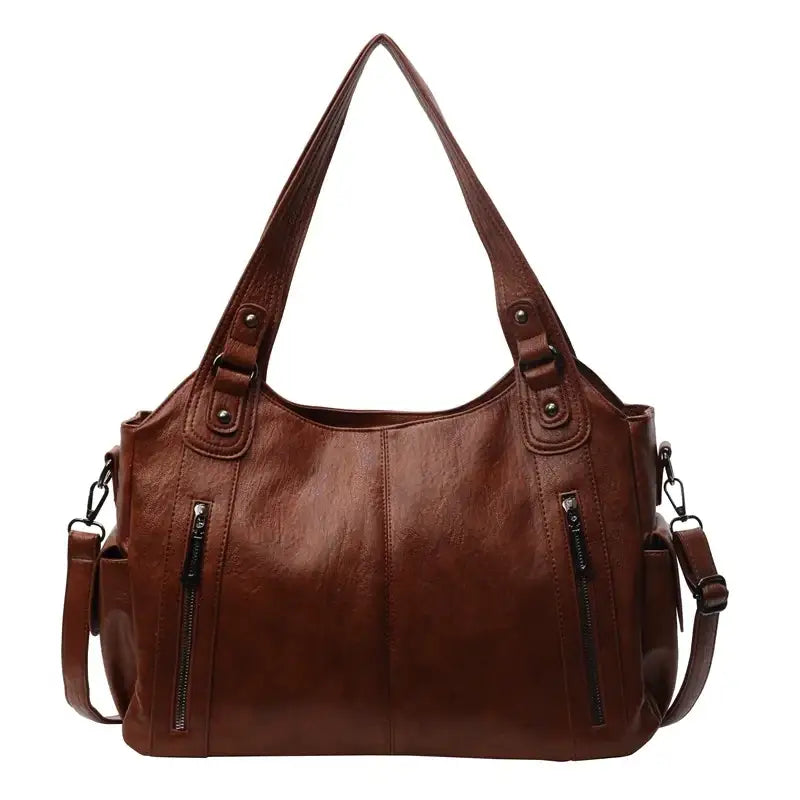 Brown faux leather shoulder bag with two front zippers and adjustable strap.