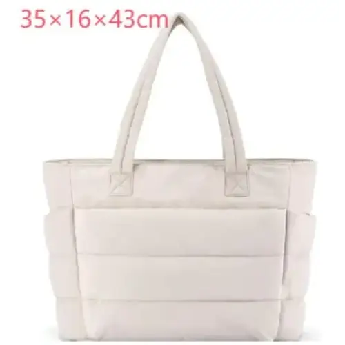 Cream-colored quilted tote bag with structured, padded design and sturdy handles.