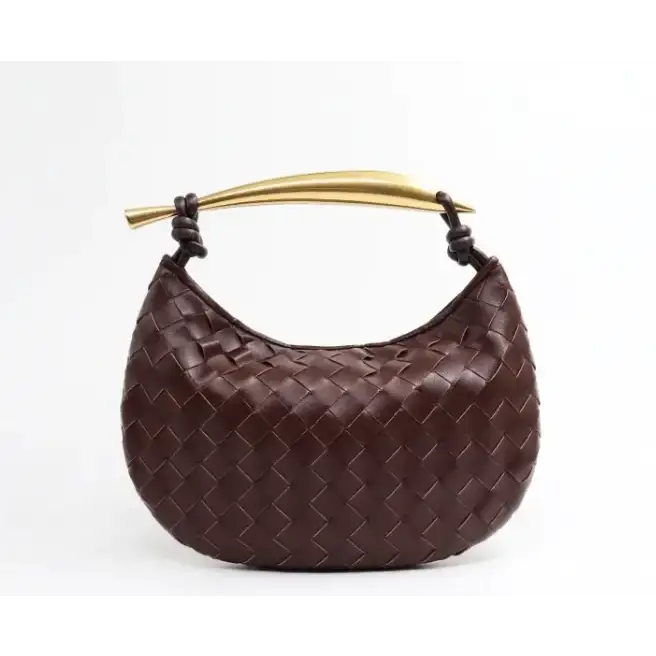 Brown leather handbag with a gold-tone handle and intricate woven pattern.
