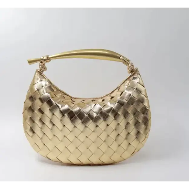 Gold-toned woven leather handbag with a sleek, curved handle.