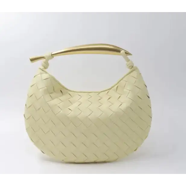 Cream-colored woven leather handbag with a gold-tone handle.