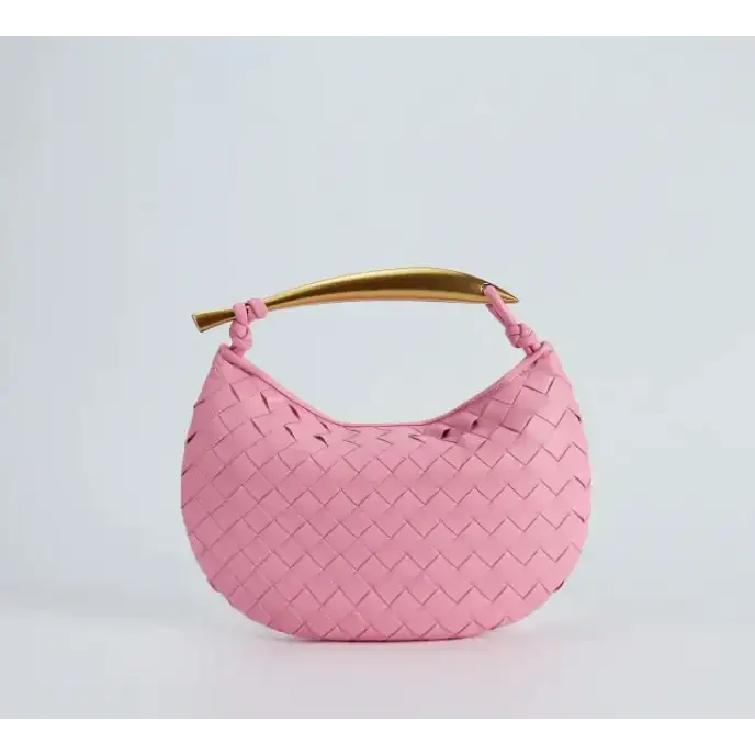 Pink woven leather handbag with a gold-tone curved handle.