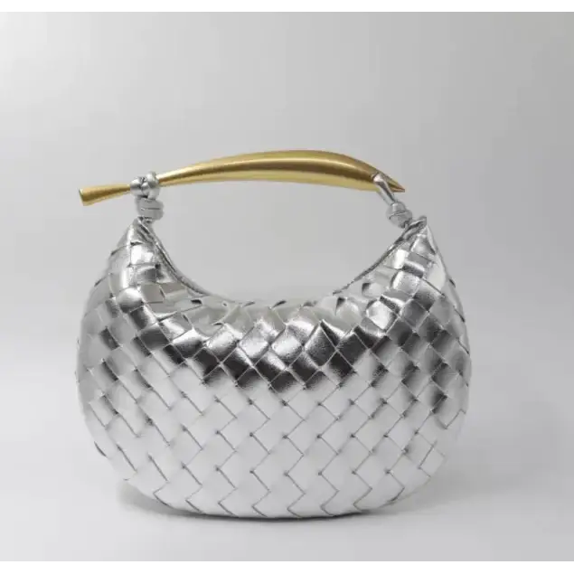 Silver woven leather handbag with a gold-tone handle.