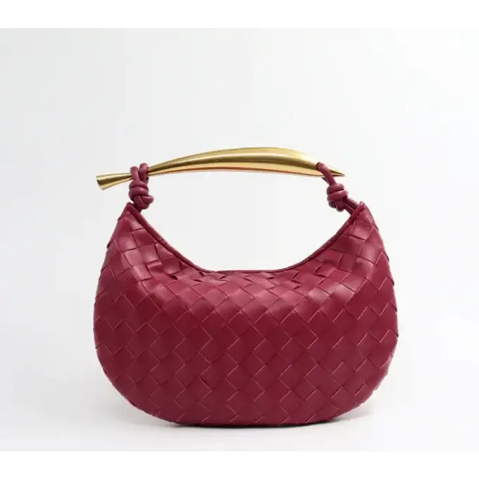 A burgundy woven leather handbag with a gold-tone handle.