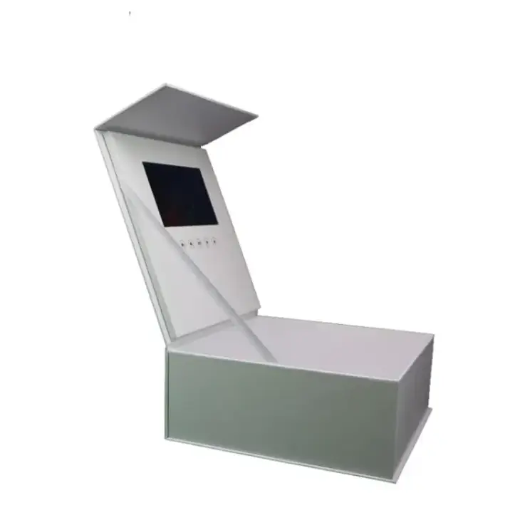White rectangular display box with a hinged lid featuring an embedded screen and control buttons.