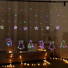 Colorful led string lights with star, reindeer, bell, and christmas tree shapes hang in a festive arrangement.