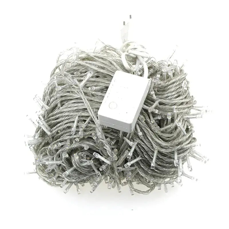 A tangled bundle of clear led string lights with a white power adapter and plug.