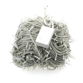 A tangled bundle of clear led string lights with a white power adapter and plug.