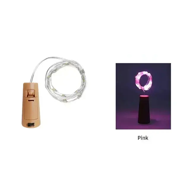 Pink led wine cork light with a beige battery-powered base and silver wire string.