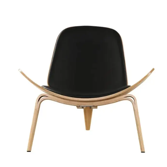 Black leather upholstered lounge chair with curved light wood frame.
