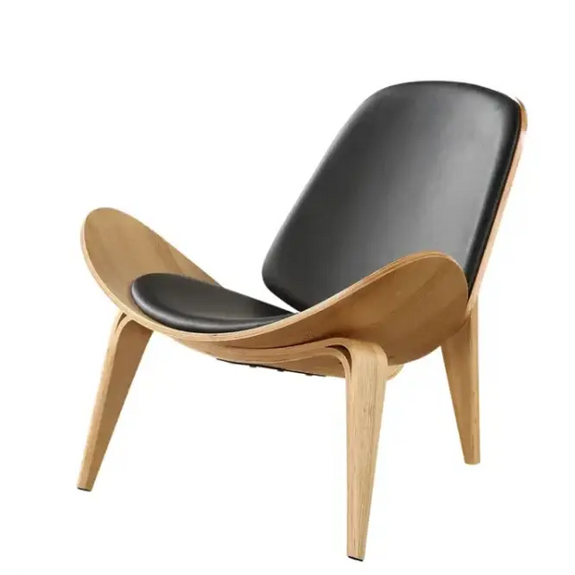 Black leather upholstered lounge chair with a sleek, curved wooden frame.