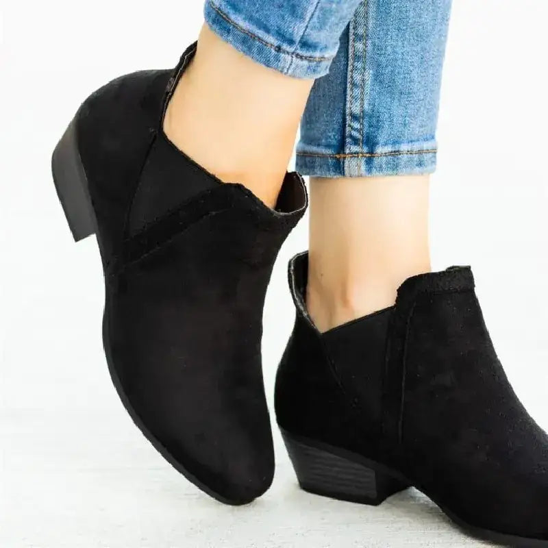 Black suede ankle boots with a low block heel and elastic side panels.