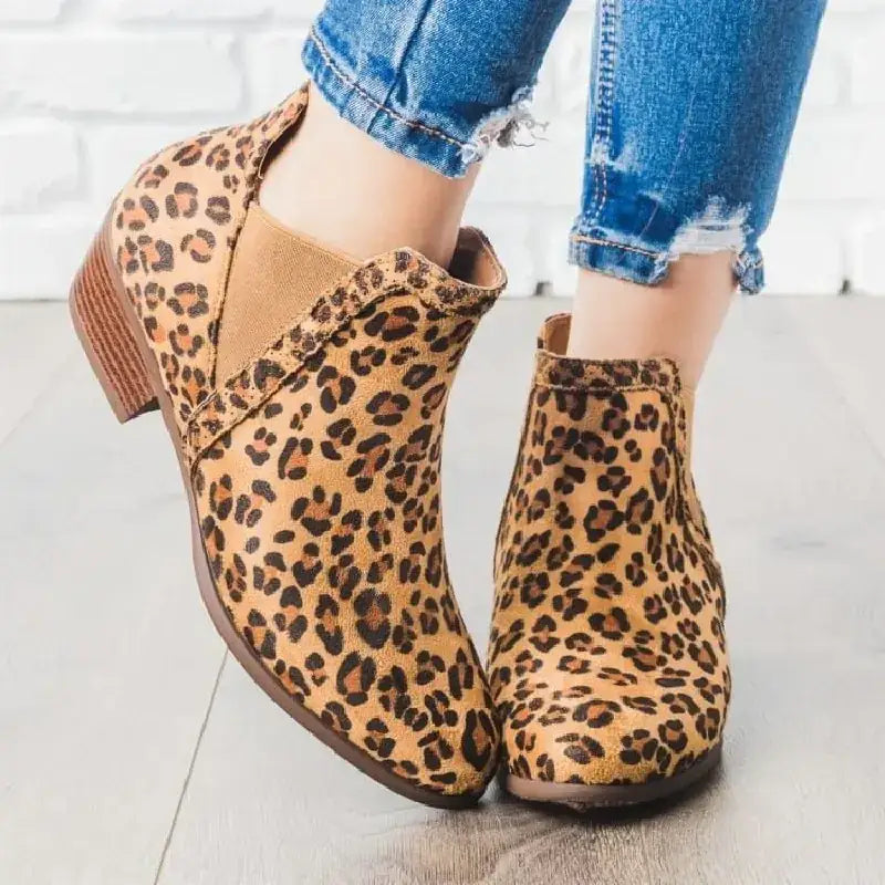 Tan and brown leopard-print suede ankle boots with a low block heel.