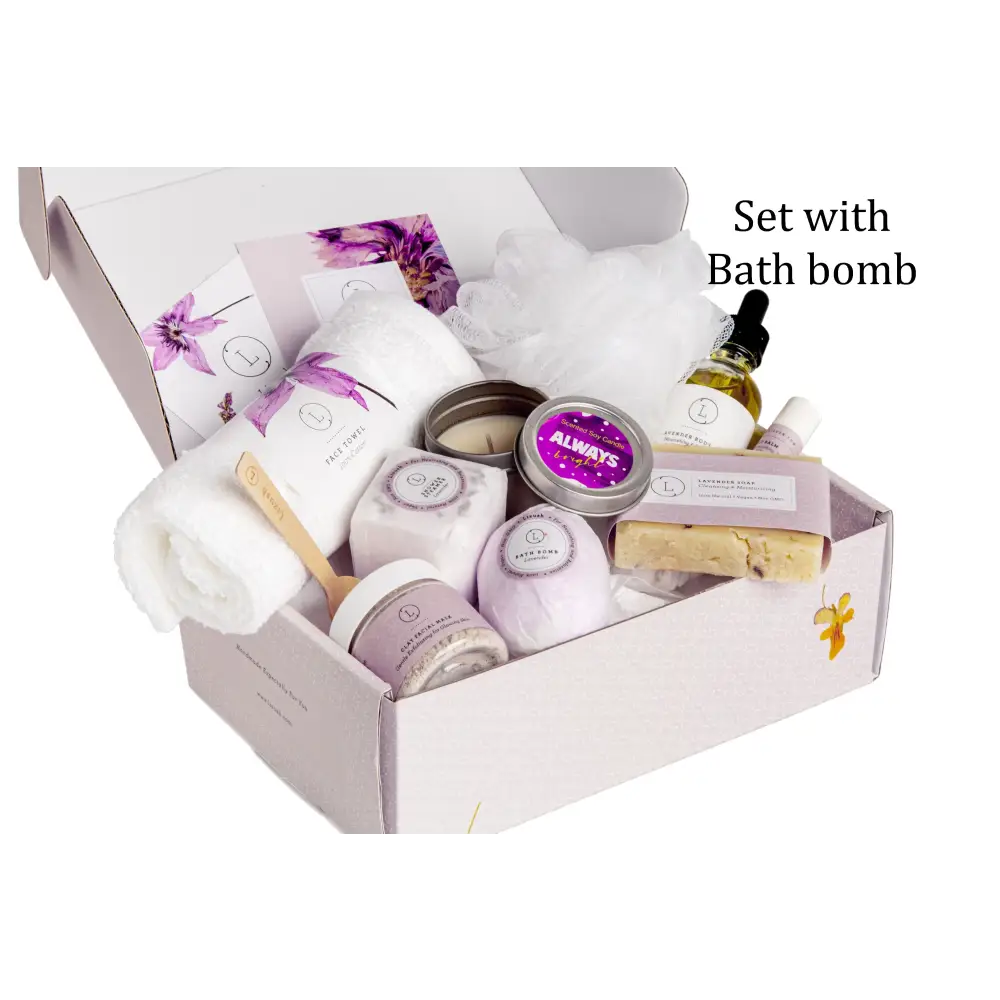 Lavender-scented bath bomb nestled in a gift box with matching purple and white packaging, surrounded by candles, soap bars, and other spa essentials.