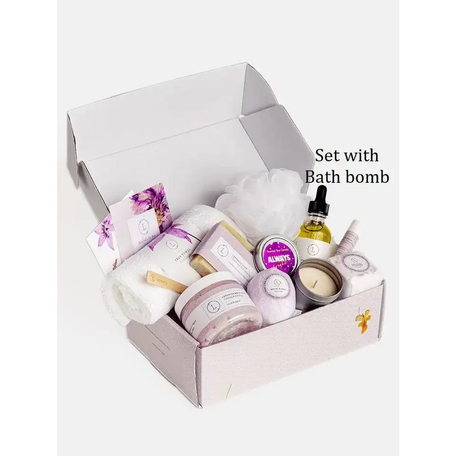 A lavender-hued bath bomb nestled among other spa items in a gift box.