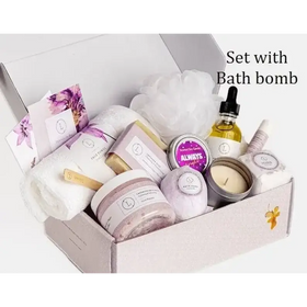 A lavender-scented bath bomb nestled among other spa items in a gift box.