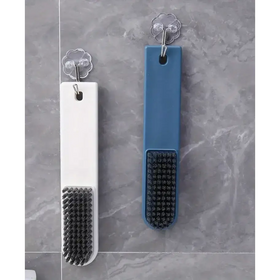 Two rectangular scrub brushes, one white and one blue, each with a black bristle head and a clear flower-shaped hook for wall mounting.