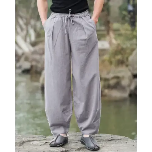 Gray, loose-fitting cotton trousers with an elastic waistband and drawstring.