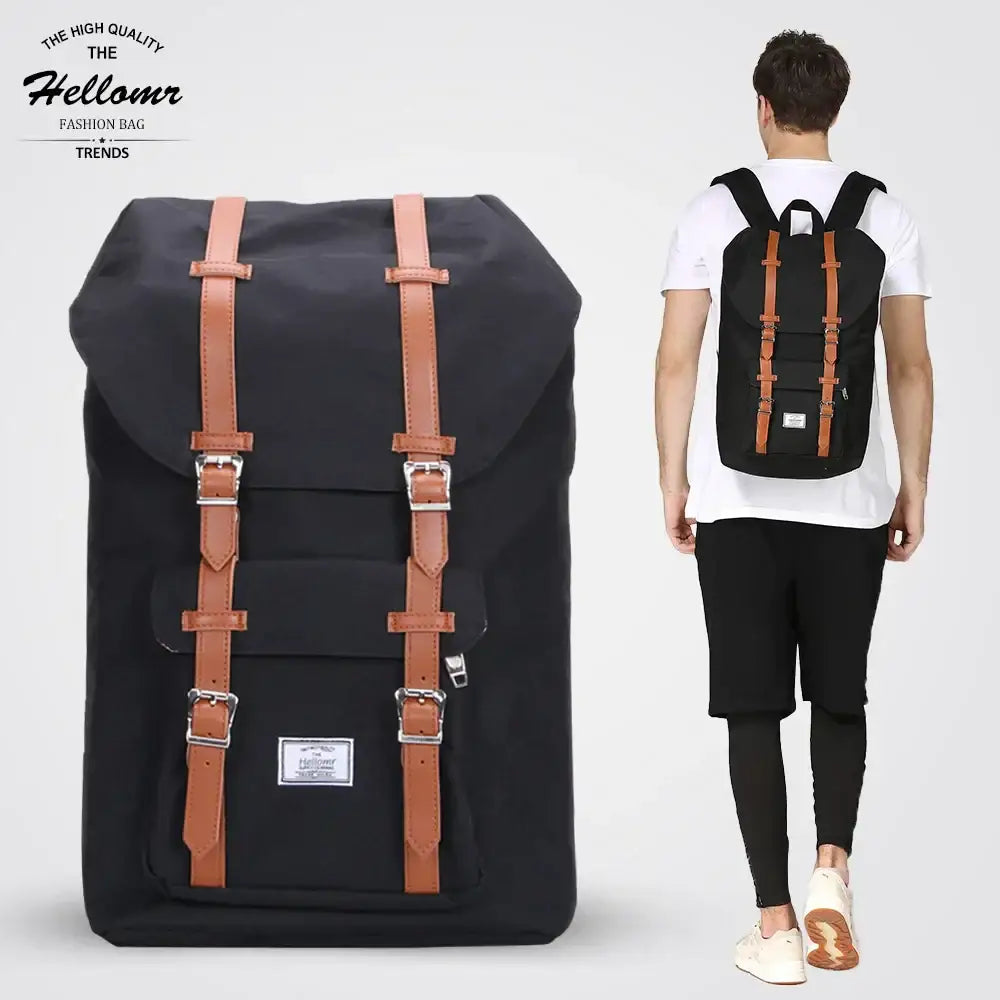 Black canvas backpack with tan leather straps and silver buckles, featuring a classic retro design.
