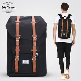 Black canvas backpack with tan leather straps and silver buckles, featuring a classic retro design.