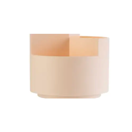 A modern, minimalist table lamp with a matte off-white cylindrical base and a warm peach-colored upper section featuring geometric cutouts.