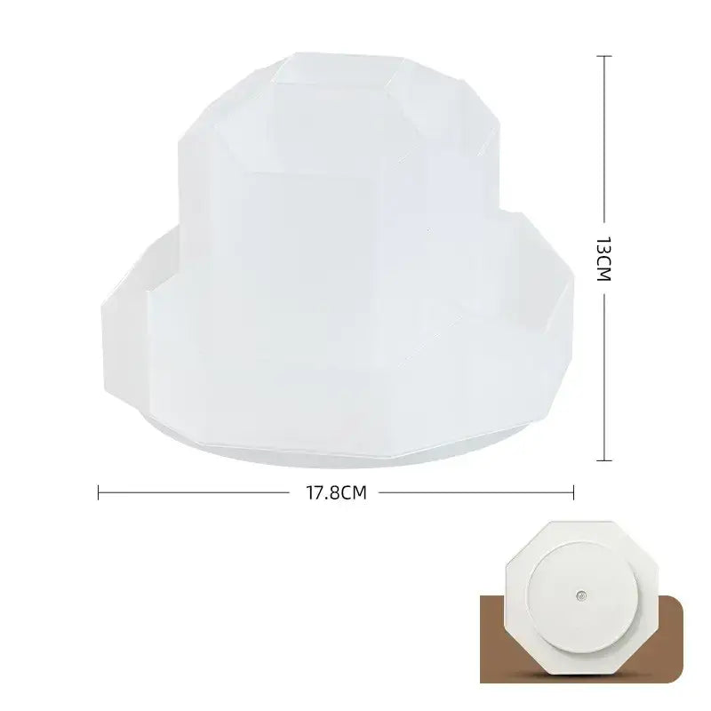 A white, geometrically faceted lampshade with a modern design.