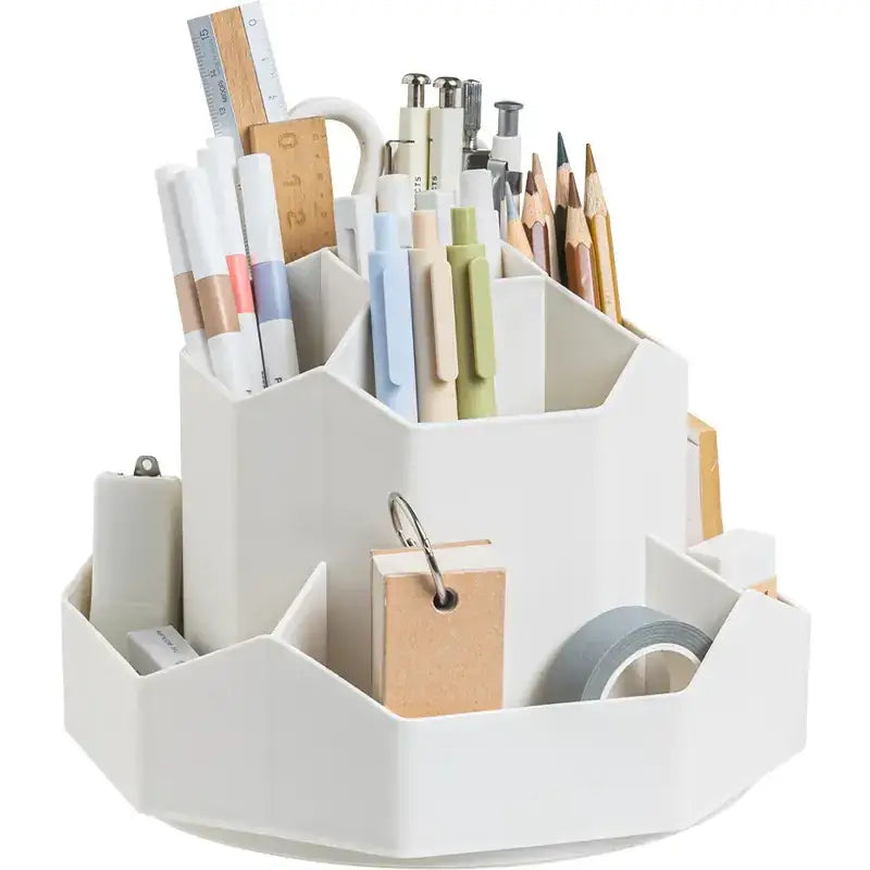 White geometric desk organizer filled with pens, pencils, markers, and office supplies.